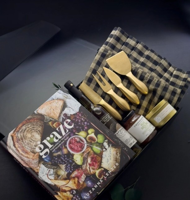 Graze cookbook paired with gold cheese tools and gingham linen