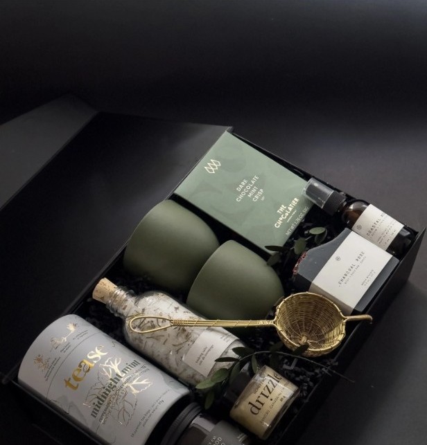Sage cocktail gift box with olive green cups and a gold strainer